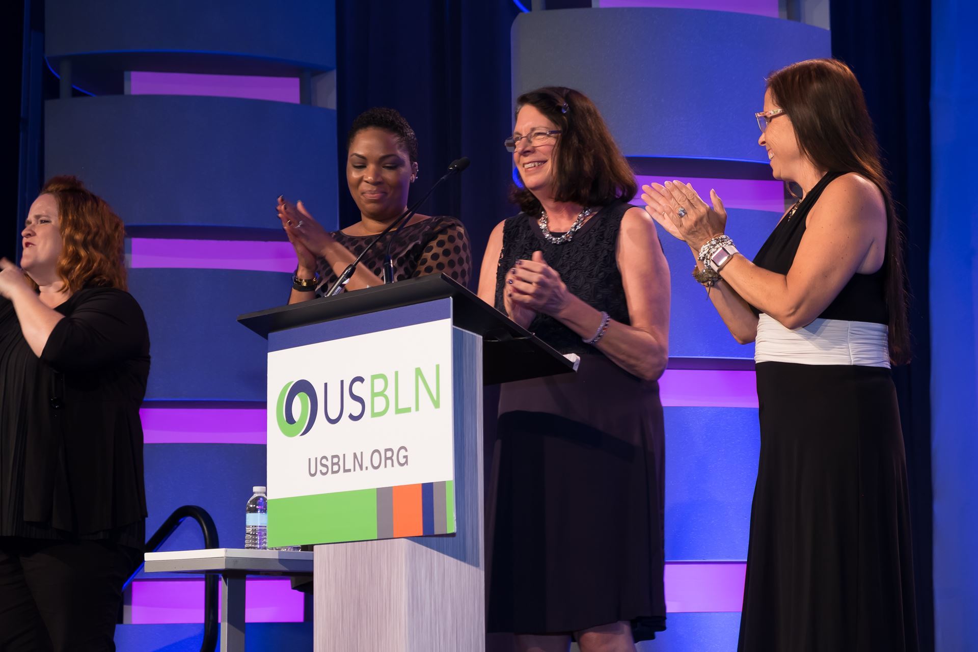 Women speaking from the podium at the USBLN Awards Event