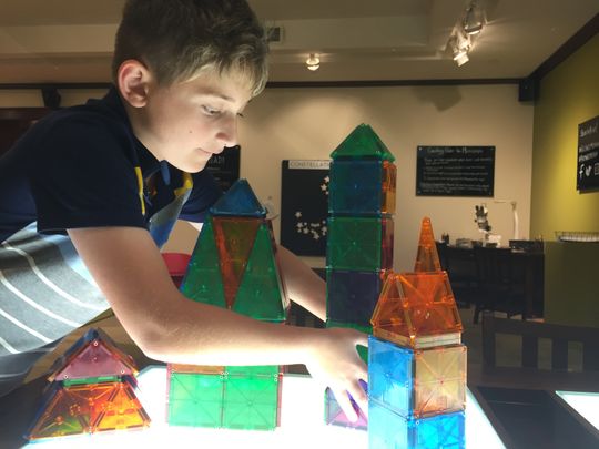Nine-year old Andrzej Huber rearranging blocks on a desk