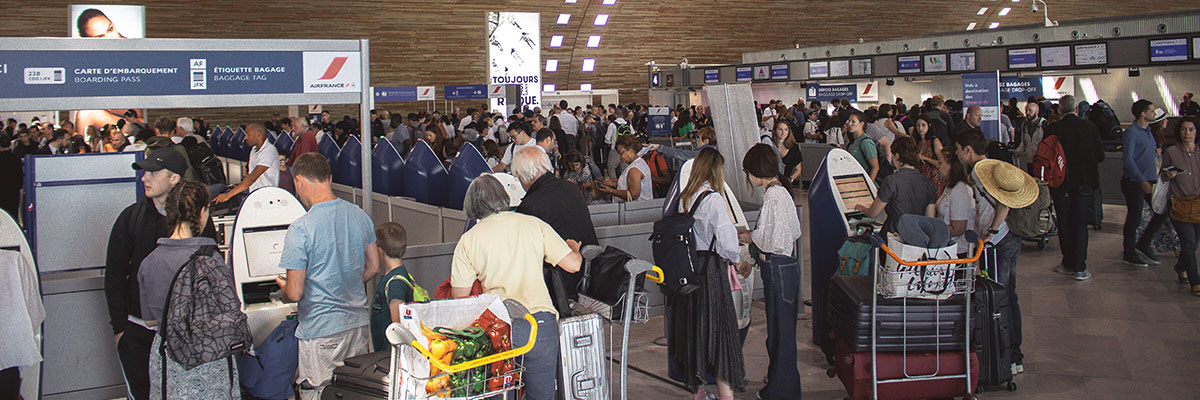 A group of people in a crowed airport terminal